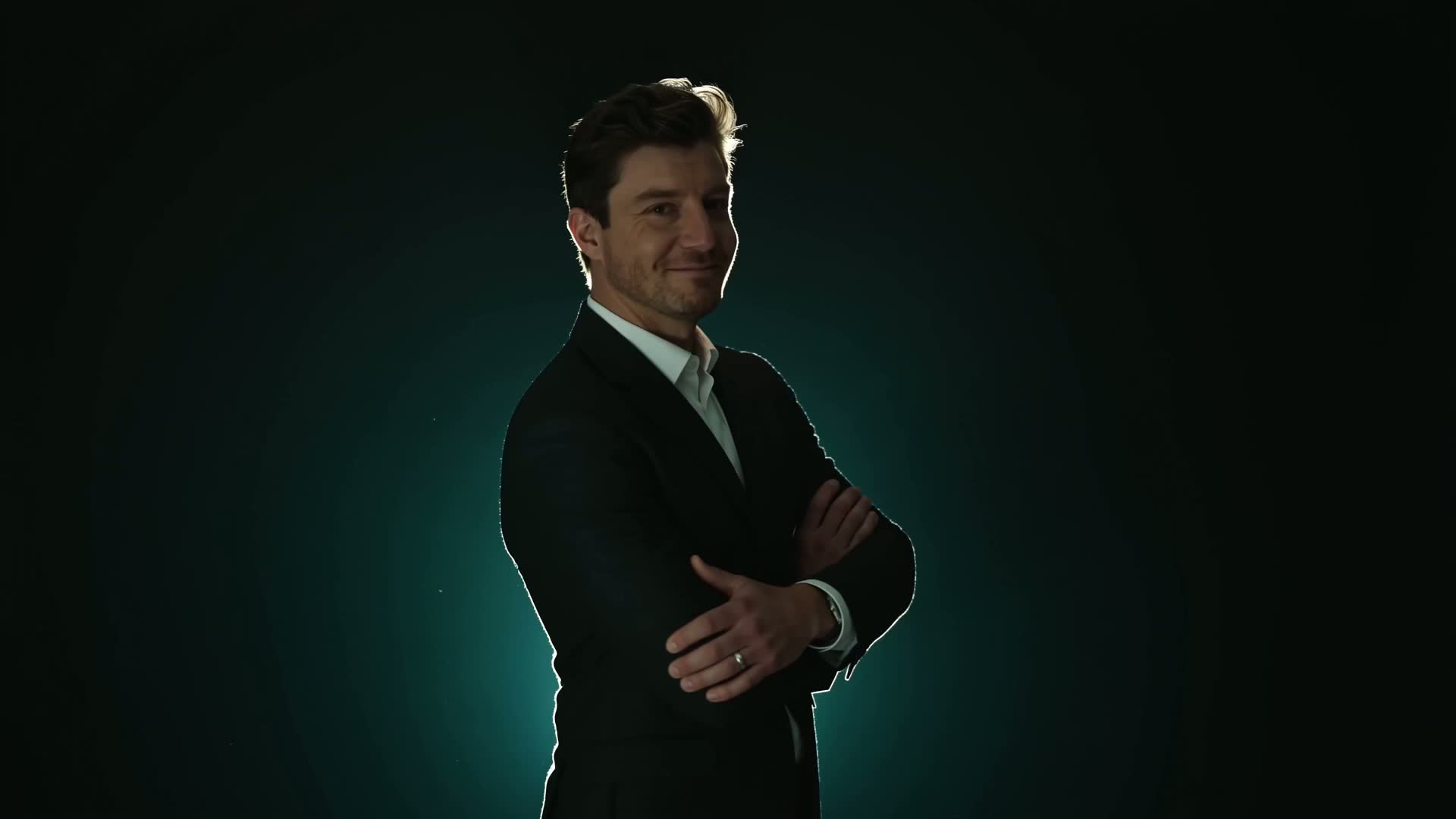 David Gardiner standing in a dark studio with green rim lighting